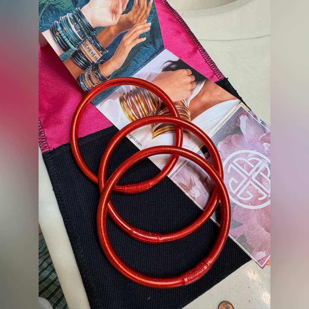 Set of three Budha Girl crimson bracelets. Like new with protective bag